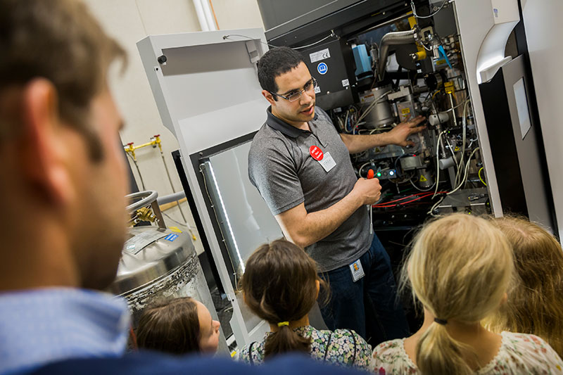 Senior staff scientist Mark Ebrahim shows the inside of a microscope during a tour of the Cryo-Electron Microscopy Center. Cryo-EM uses beams of electrons to image protein samples that have been flash-frozen at cryogenic temperatures, revealing their atomic structures.