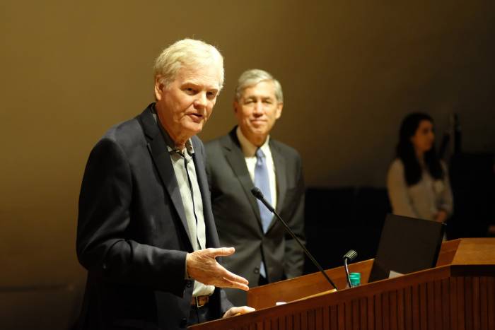 Rockefeller president Richard P. Lifton looks on as Young speaks at the press conference.