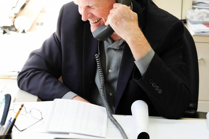 Young smiles as he takes one of many calls after the Nobel announcement.