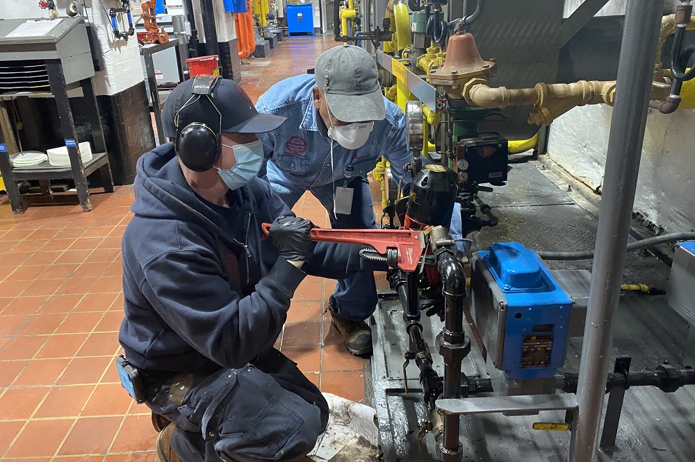 Plant Operations employees making repairs.