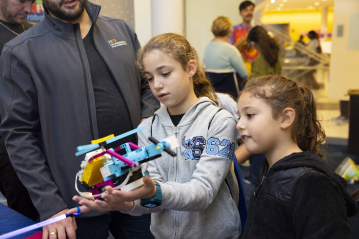 At the “SPIKE Robotics & Game Coding” booth kids got hands-on with LEGO robotics kits.