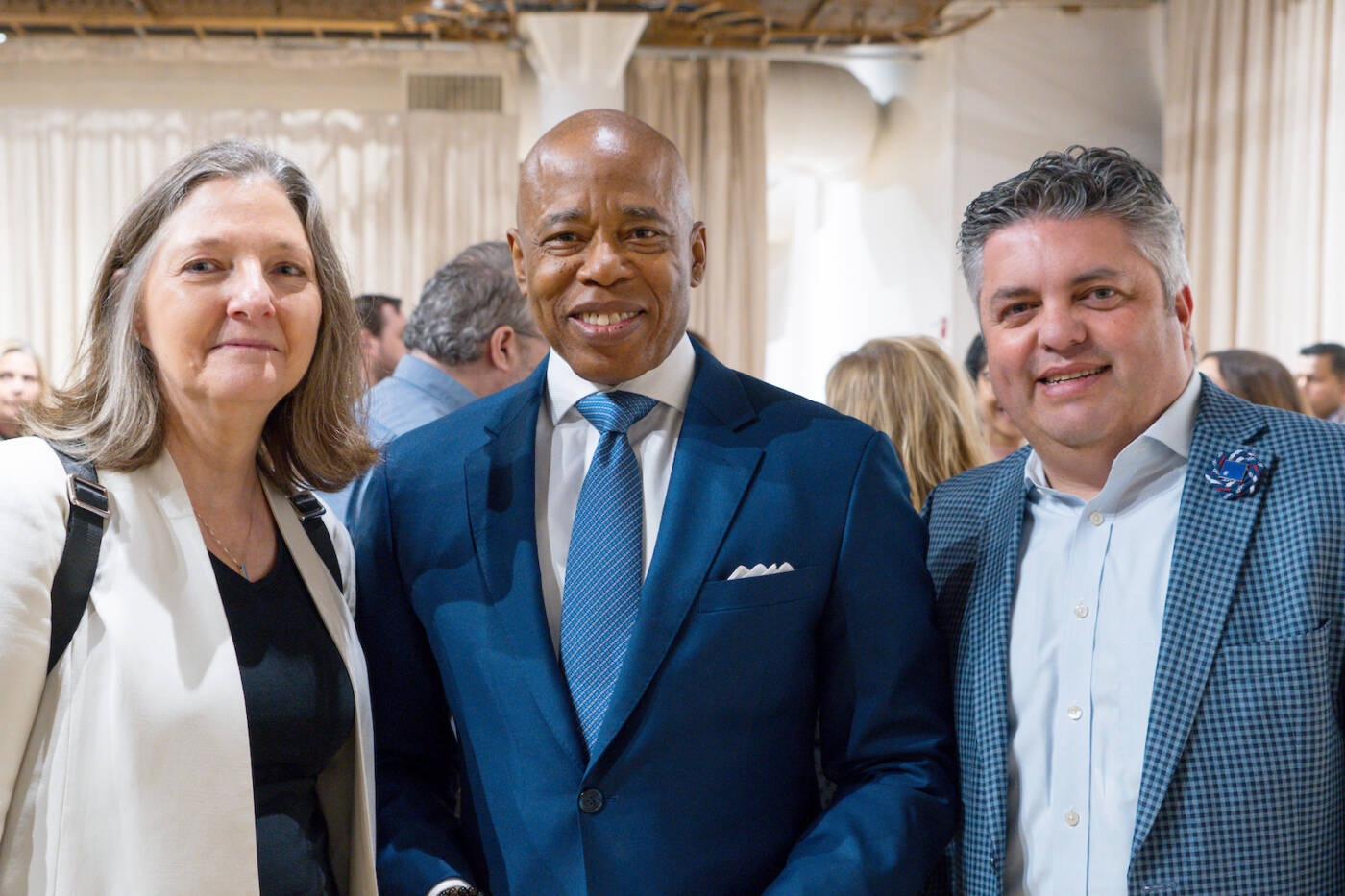 Rockefeller's Amy Wilkerson (left) and Alex Kogan (right) with NYC Mayor Eric Adams (center)