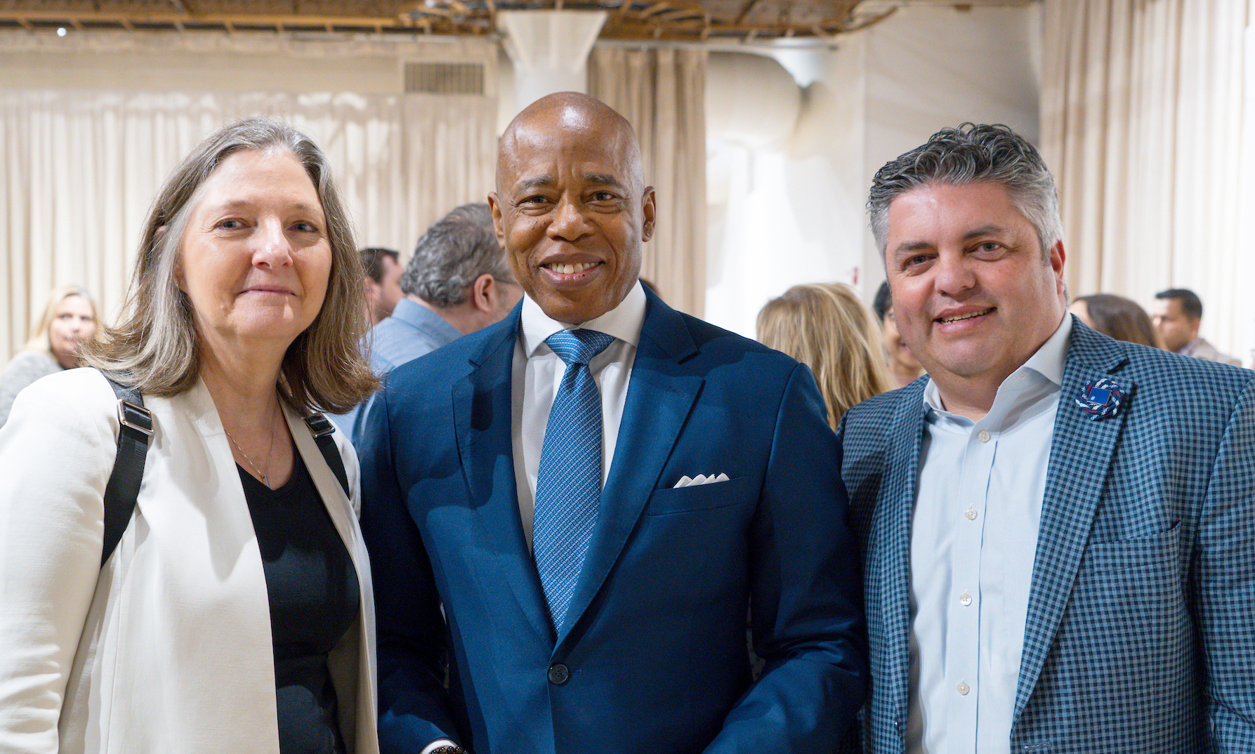 Rockefeller's Amy Wilkerson (left) and Alex Kogan (right) with NYC Mayor Eric Adams (center) 