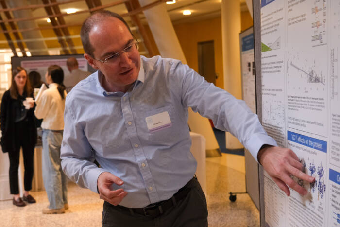 Dr. Nicolas Svetec explains his research to attendees of the 2025 Hess Center Symposium.