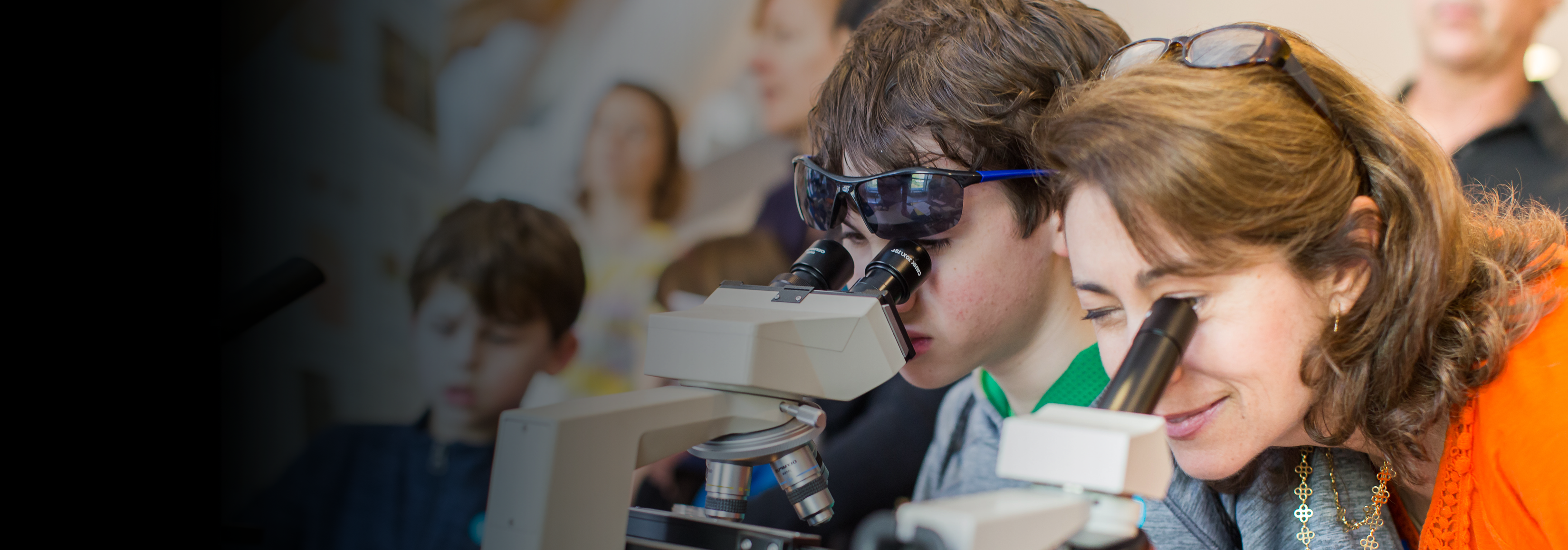 Student and teacher at microscope