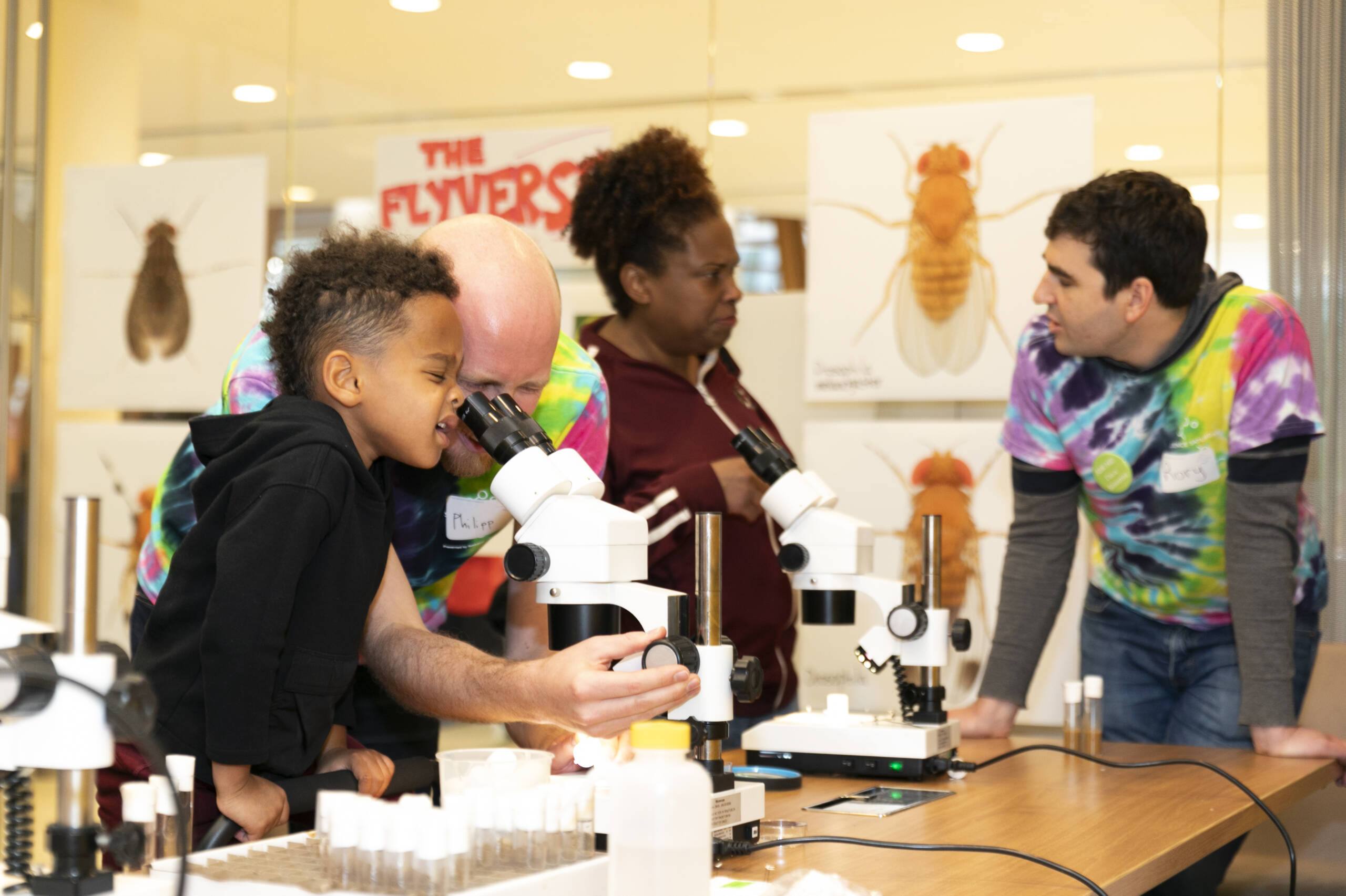 Rory Coleman and Philipp Brand, of the Ruta lab, helped visitors observe different fruit fly species used by neuroscientists.