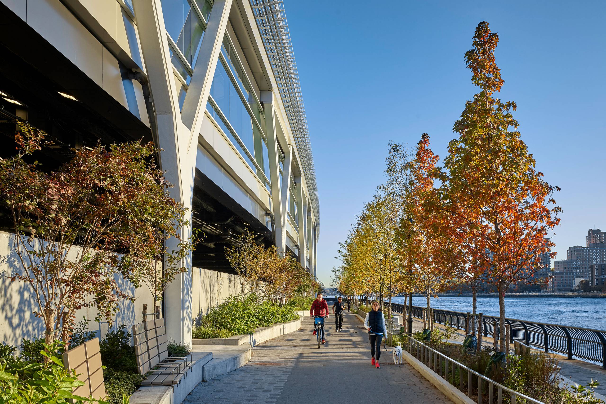 East River Esplanade with people walking and riding their bikes.