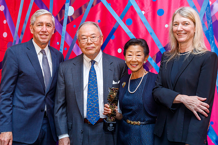 Honorees Lulu and Tony Wang (center) accepting the 2019 Enlightened Philanthropy Award from Rick Lifton (left) and Cori Bargmann (right)